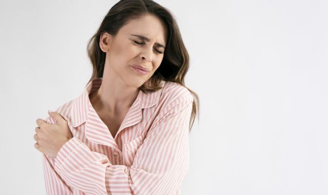 Woman suffering from shoulder pain