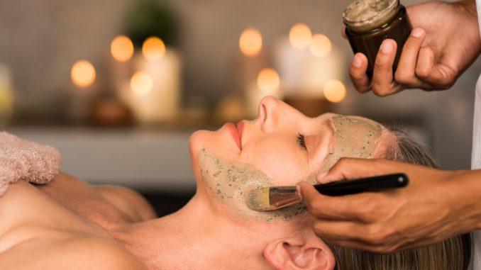 Woman with clay mask on face